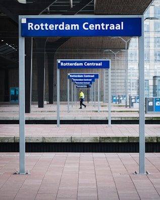 man in black pants under blue metal frame