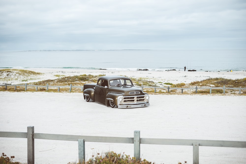 vintage brown pick-up truck near sea shore