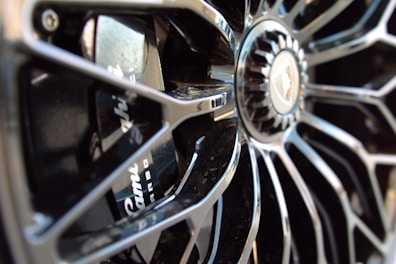 A close-up of a stylish chrome wheel with intricate designs.