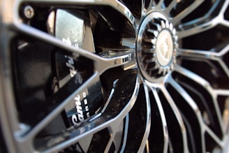 A close-up of a stylish chrome wheel with intricate designs.