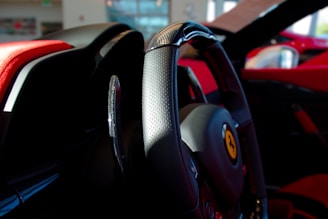 Interior view focusing on premium leather steering wheel and bespoke stitch details.