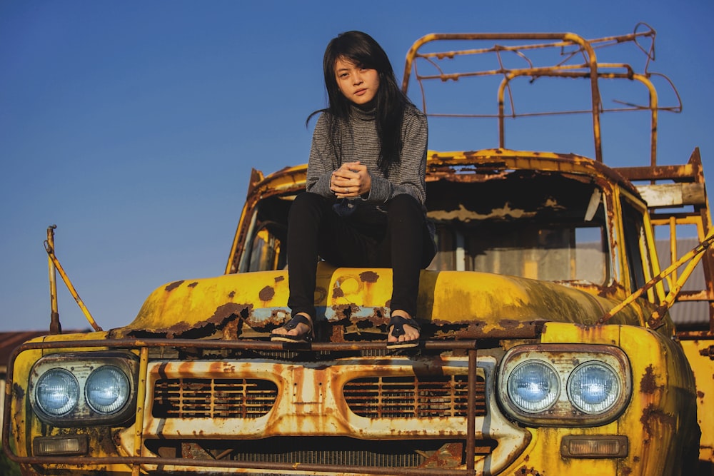 woman on top of vehicle