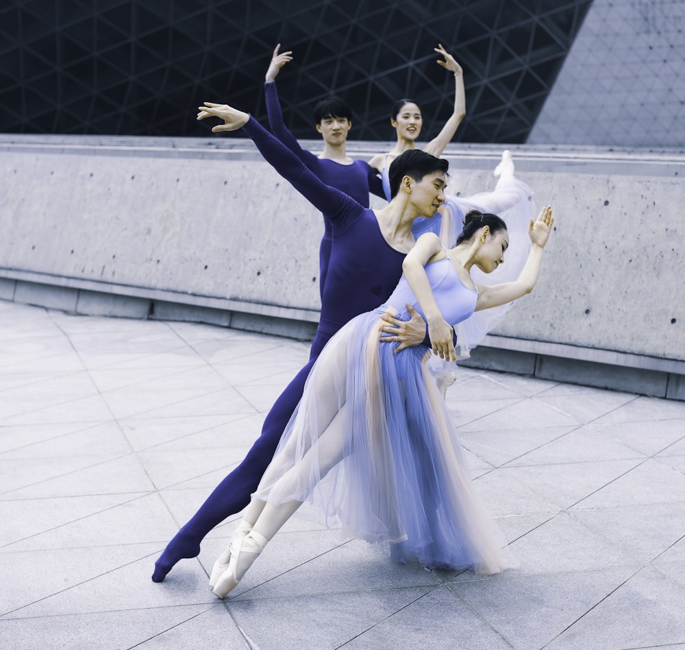 two couple dancing near gray wall