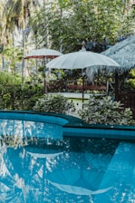 calm pool water near patio umbrella
