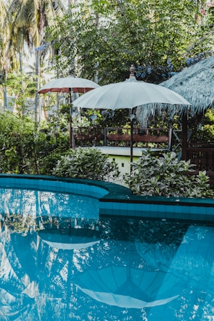 calm pool water near patio umbrella