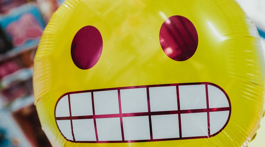 yellow inflatable smiling emoji balloon in focus photography