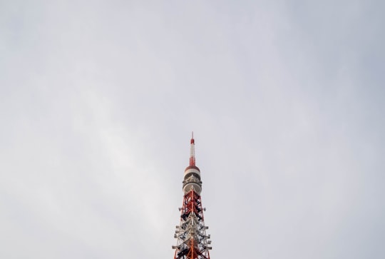 low angle photography of red and white concrete tower in Tokyo Tower Japan