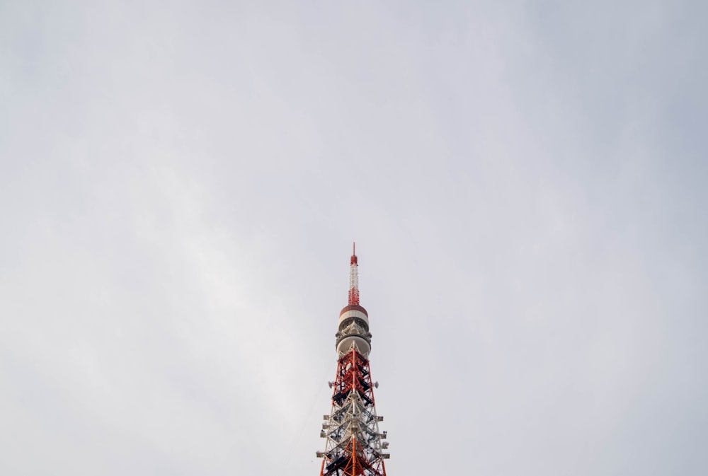 low angle photography of red and white concrete tower