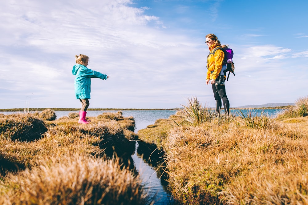 mother and daughter standing on cliffs