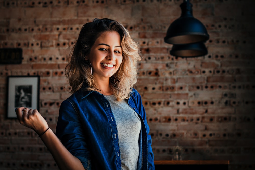 woman standing near pendant lamp