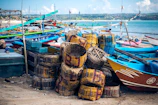 Colorful traditional boats docked at a lively coastal village.