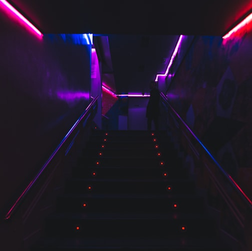 black and white staircase with purple lights