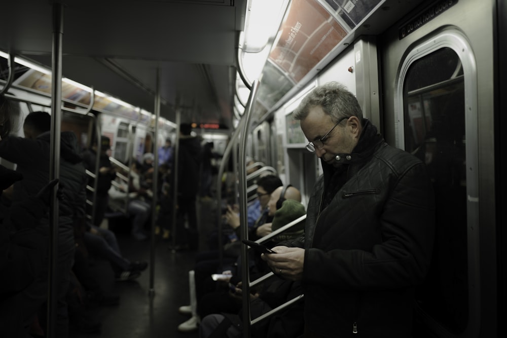 man in gray coat standing near train door