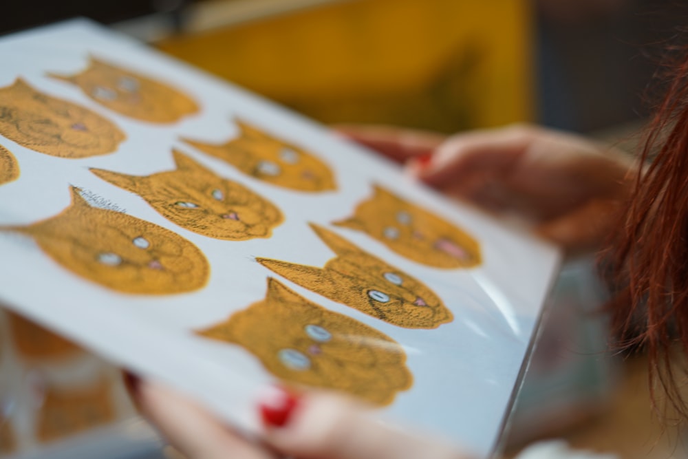 person holding white and yellow paper