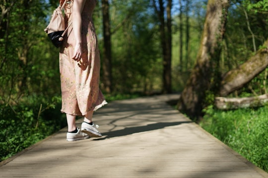 woman walking on forest trail in Didsbury United Kingdom