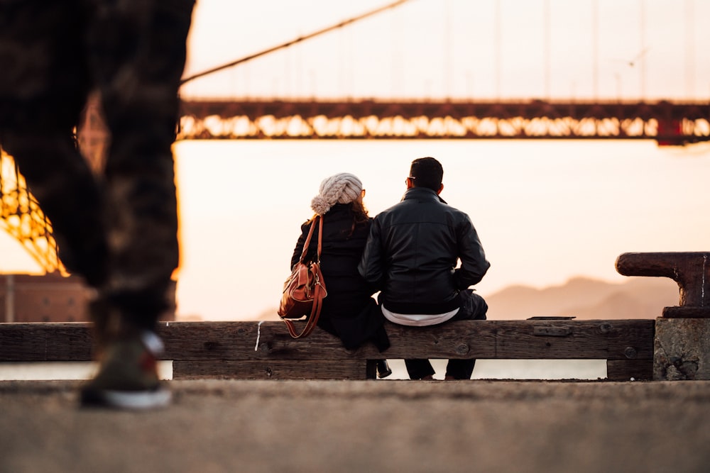 man sitting beside woman also sitting outside