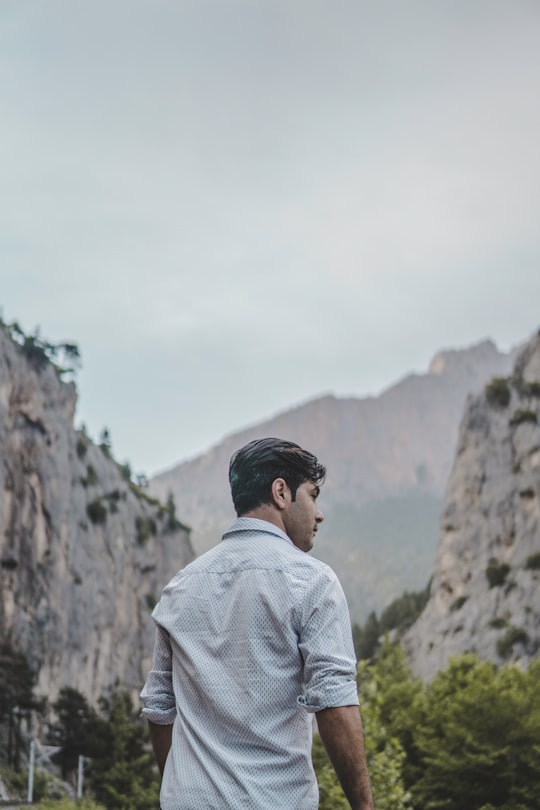 man facing rock formation at daytime in Belemedik Turkey