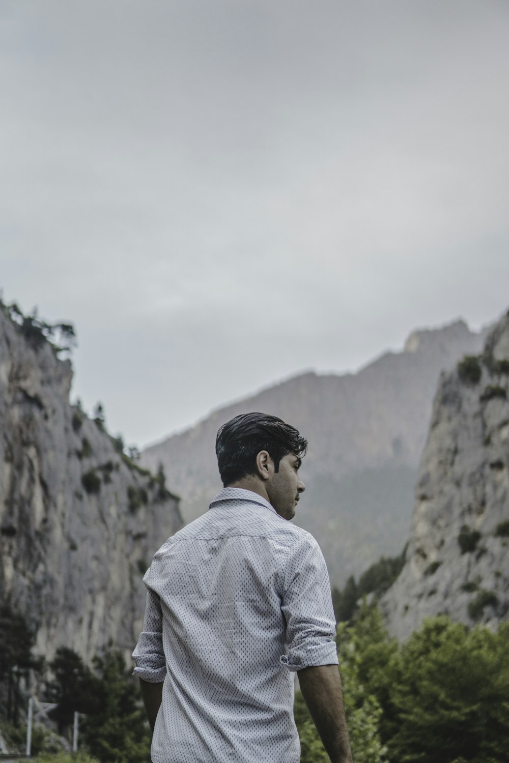 man facing rock formation at daytime