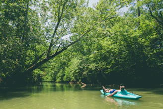 A serene kayak gliding along the calm waters of the Niagara River surrounded by lush greenery.