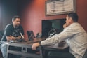 man sitting in front of another man also sitting inside room