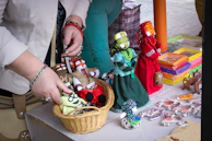 Close-up of a small business owner arranging handmade crafts on display.