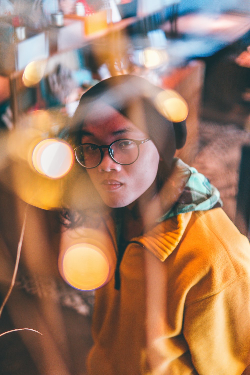 person wearing eyeglasses and knit cap