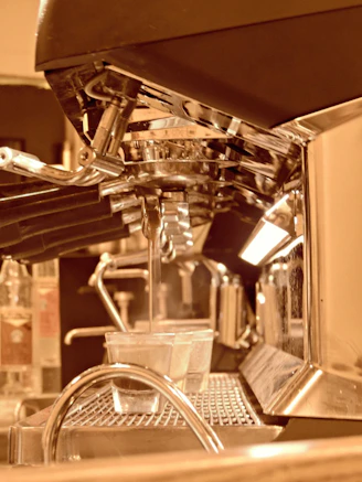 A sleek, gently used espresso machine surrounded by animated coffee beans swirling in warm tones.