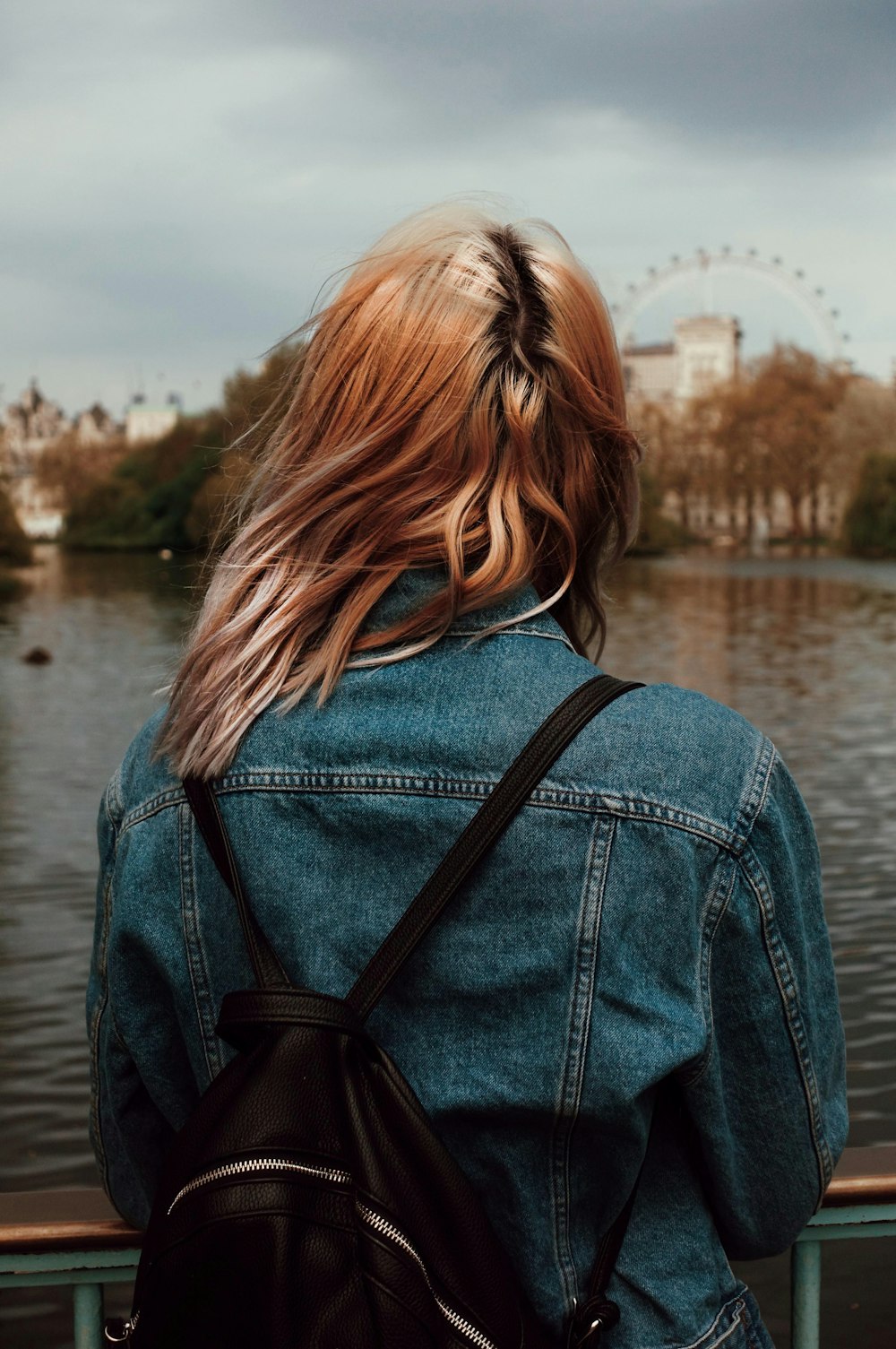 woman standing on docking pier looking straight ahead