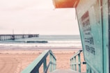 teal wooden lifeguard shed near seashore