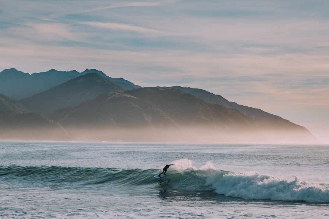 person surfing on body of water,