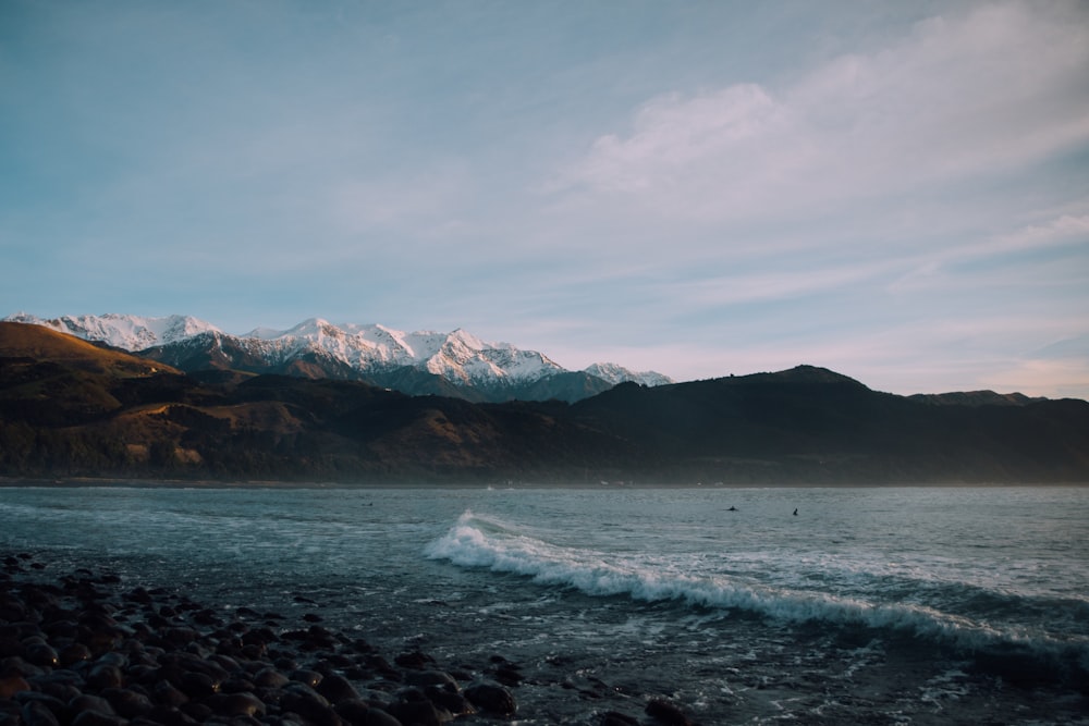 landscape photography of mountains and body of water