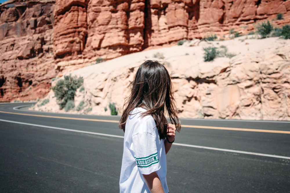 woman standing beside the road during daytime