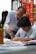 A professional tutor explaining Chinese characters during a virtual lesson.
