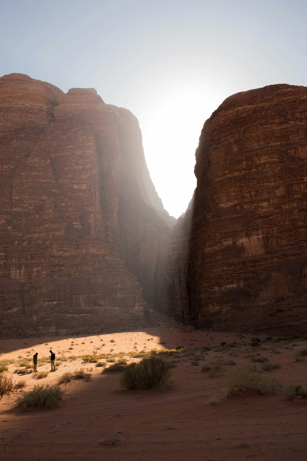 two person standing near the mountains