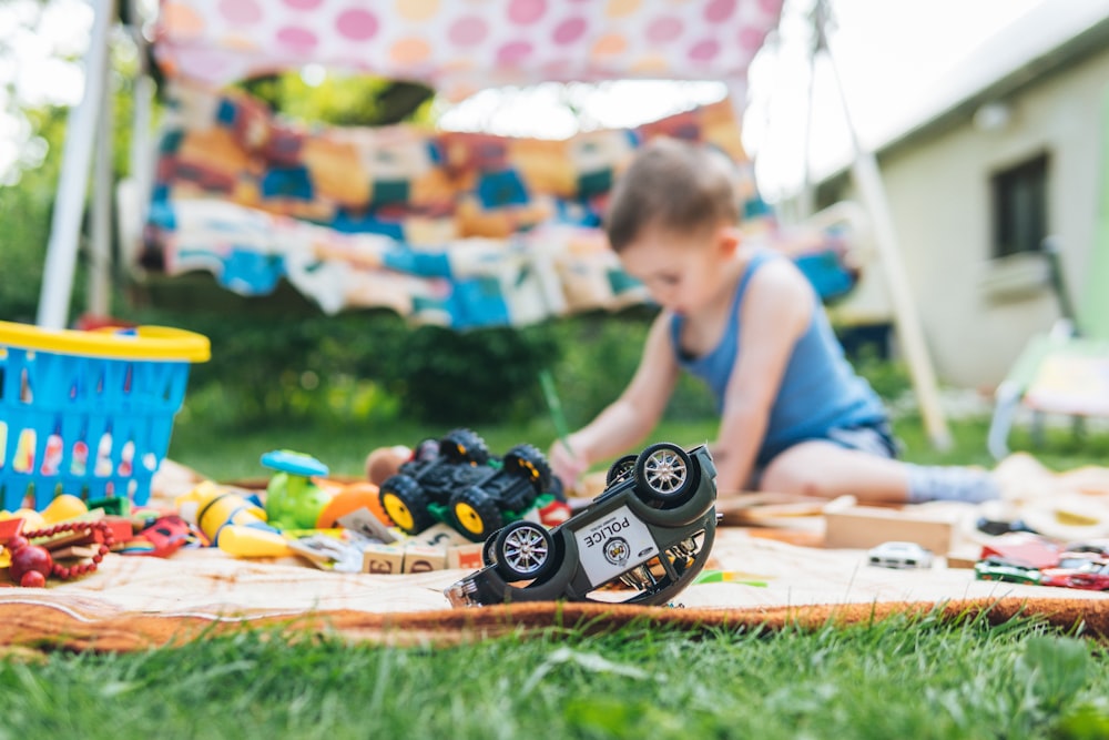 boy playing toy car