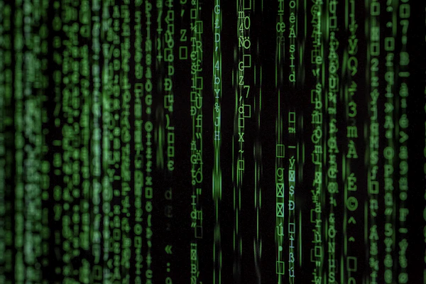 Matrix digital code green background representing AI data processing and machine learning