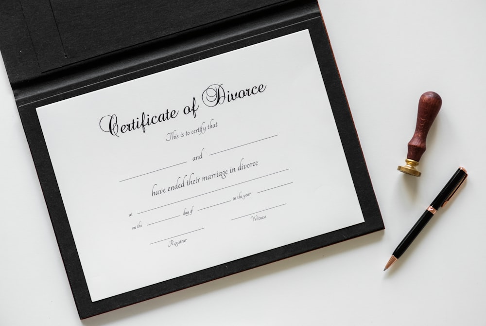 Certificate of Divorce printer paper beside twist pen