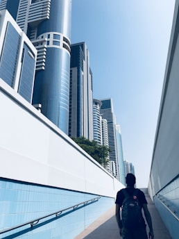 man standing on hallway near buildings during daytime