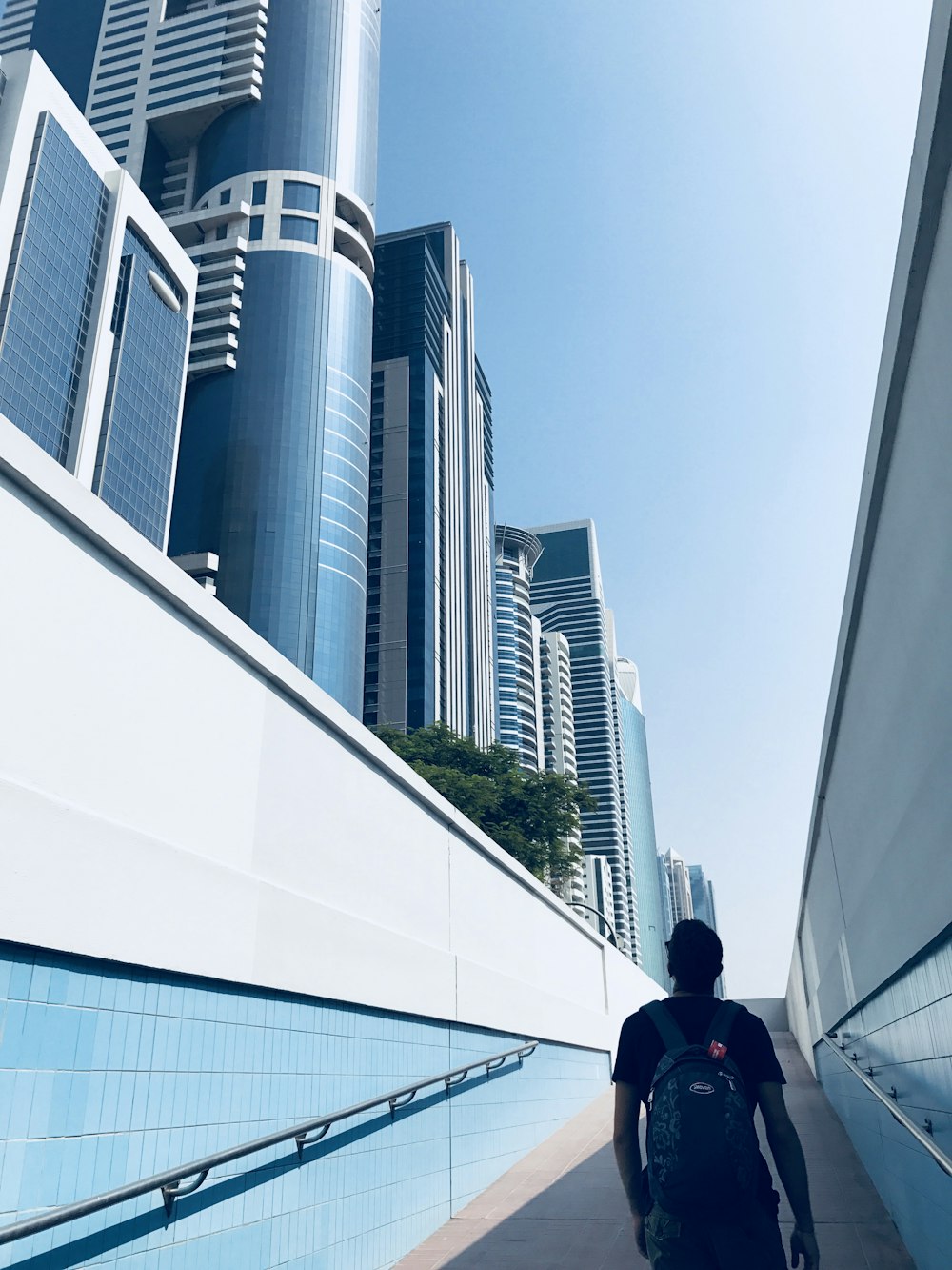 man standing on hallway near buildings during daytime