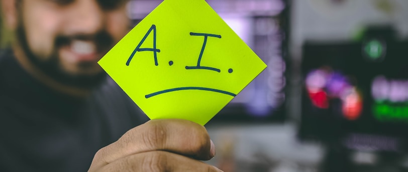 person holding green paper with the letters AI on it