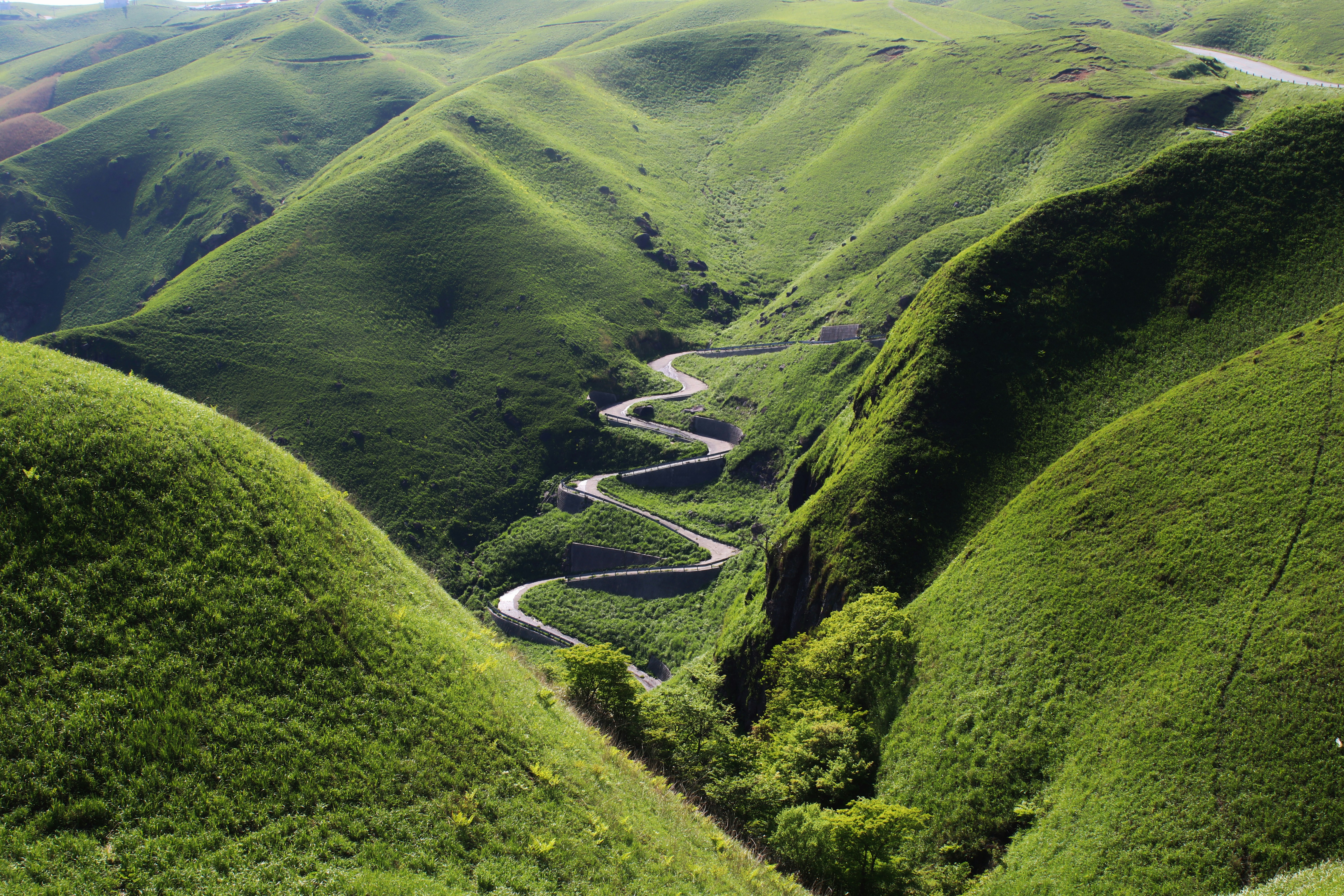 great photo recipe,how to photograph came across this perfectly snaking road on a short stop driving in aso, japan.; aerial view of mountain hills