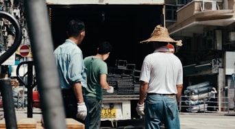 three men unloading silver frames