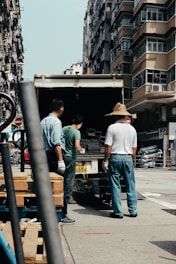 three men unloading silver frames