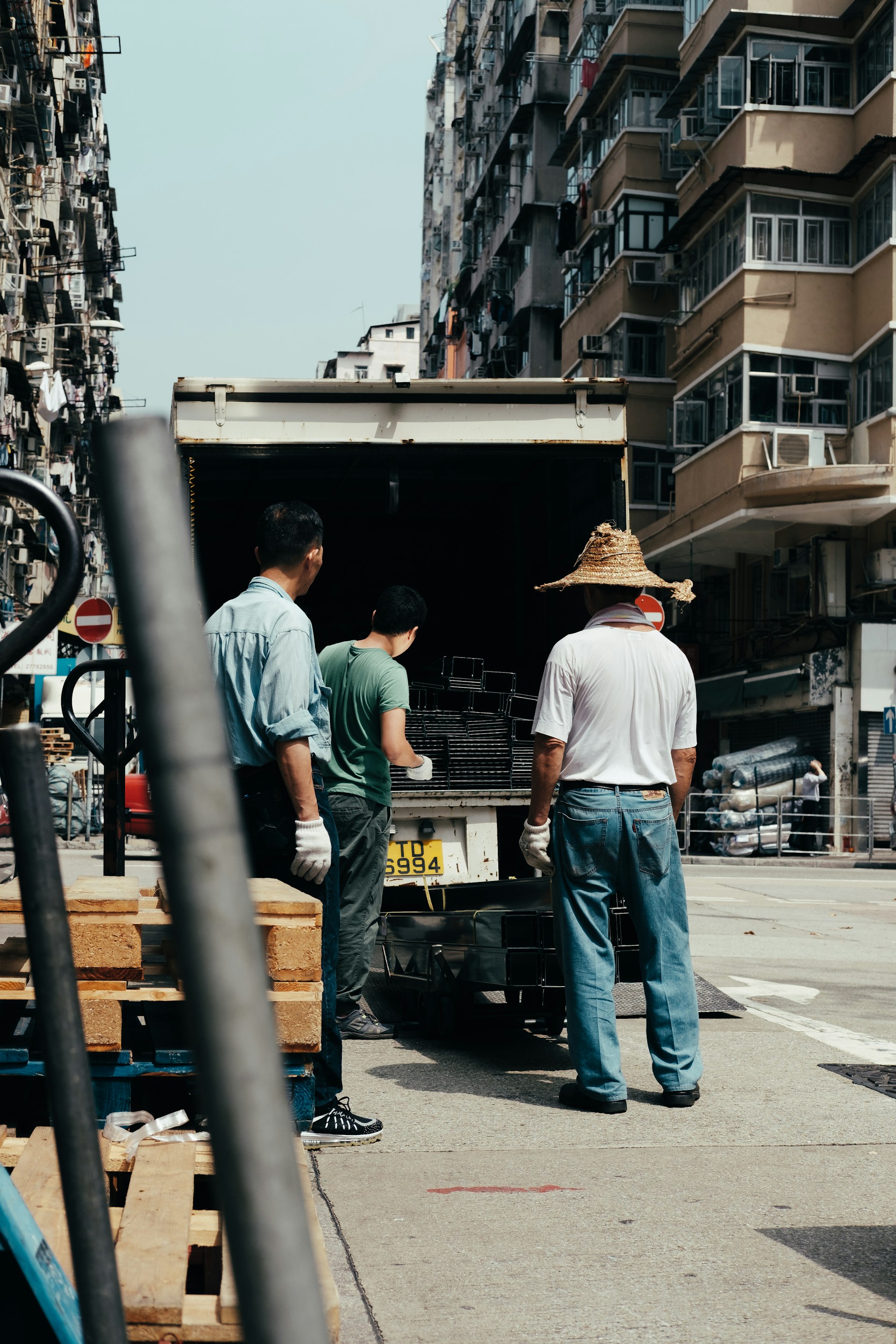 three men unloading silver frames