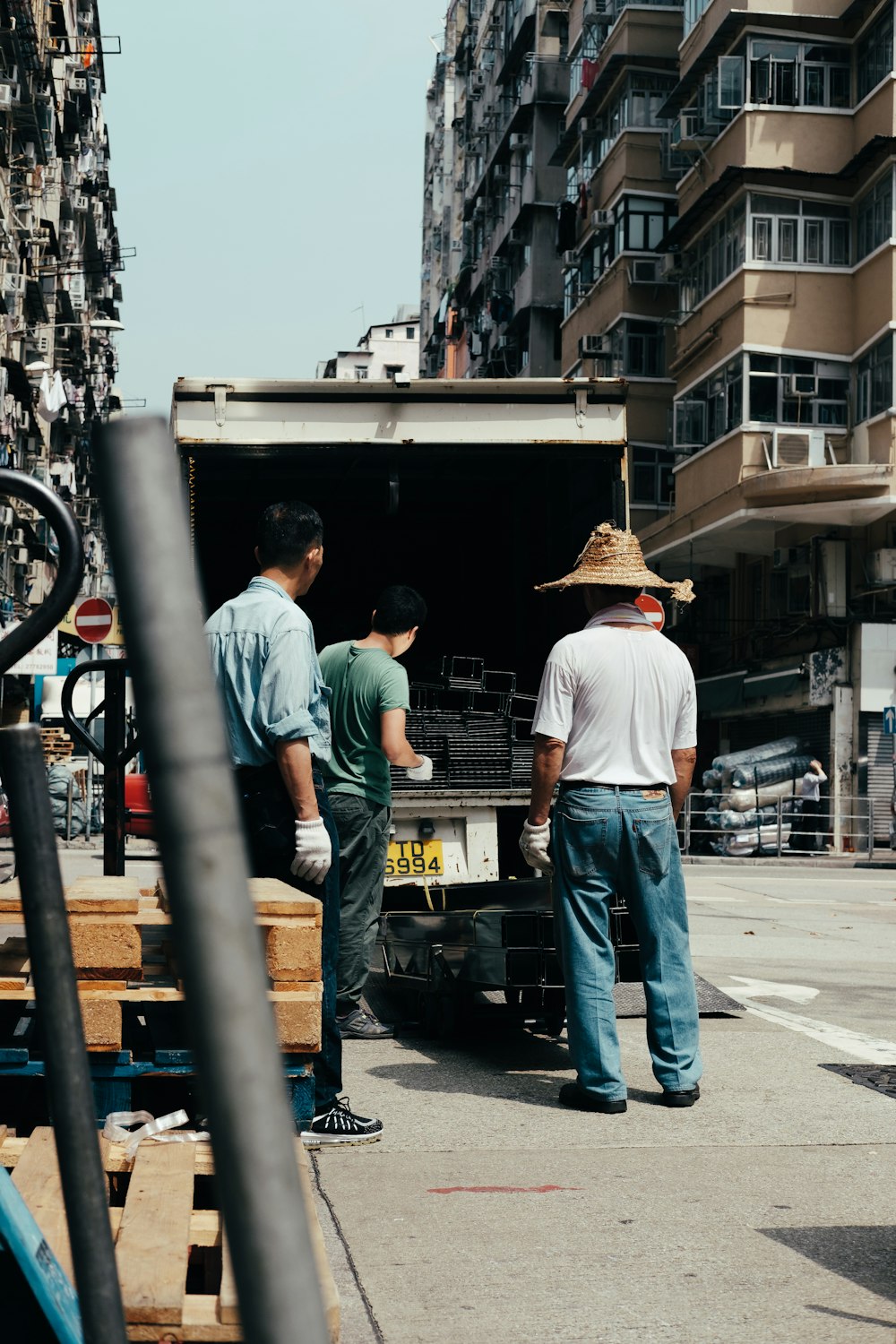 three men unloading silver frames