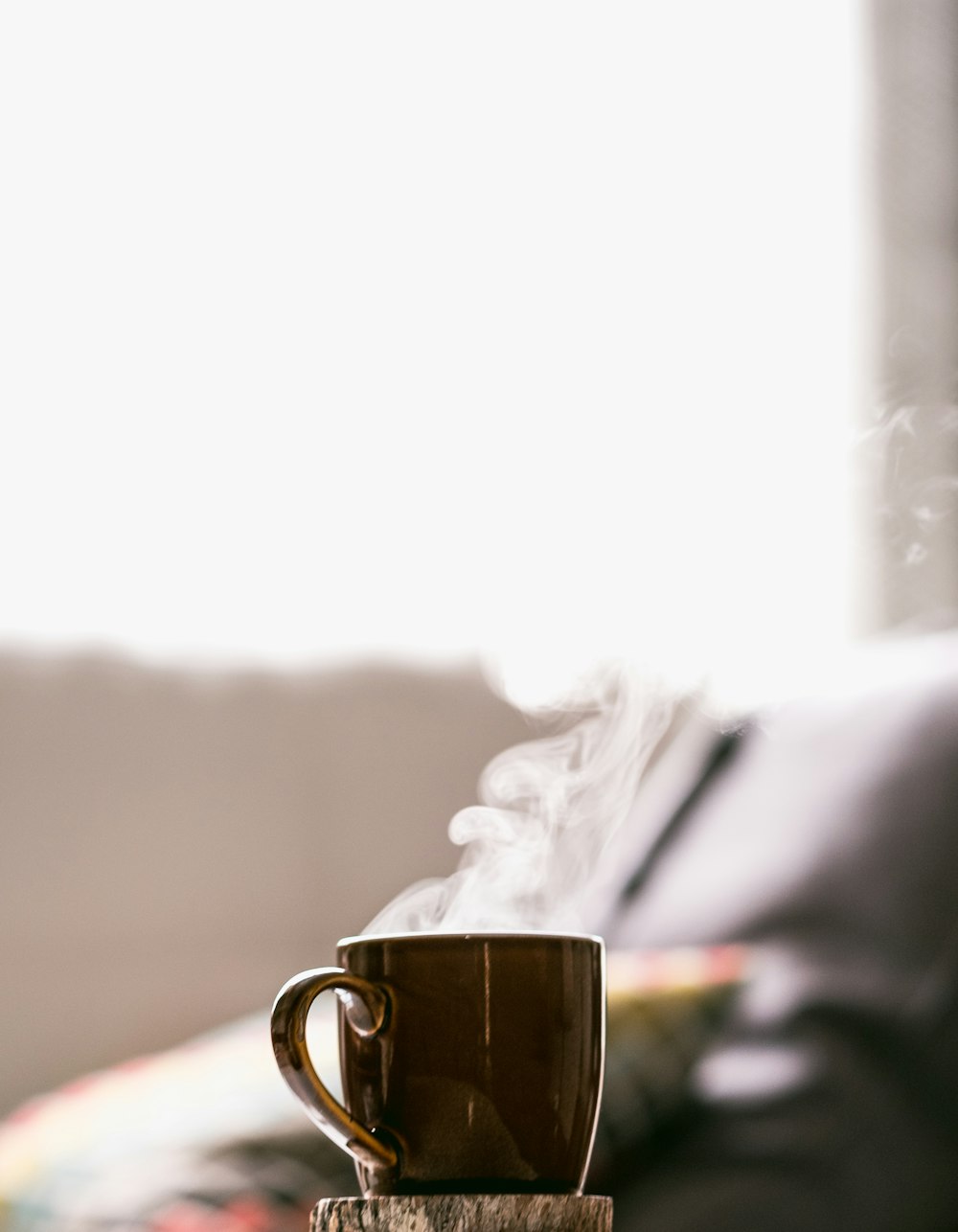 shallow focus photography of hot coffee in mug with saucer