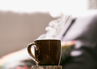 shallow focus photography of hot coffee in mug with saucer