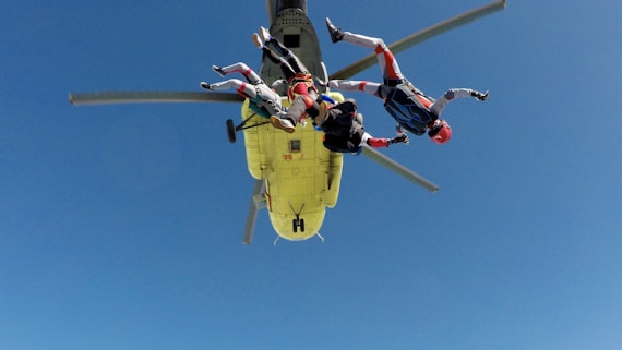 three skydiving people