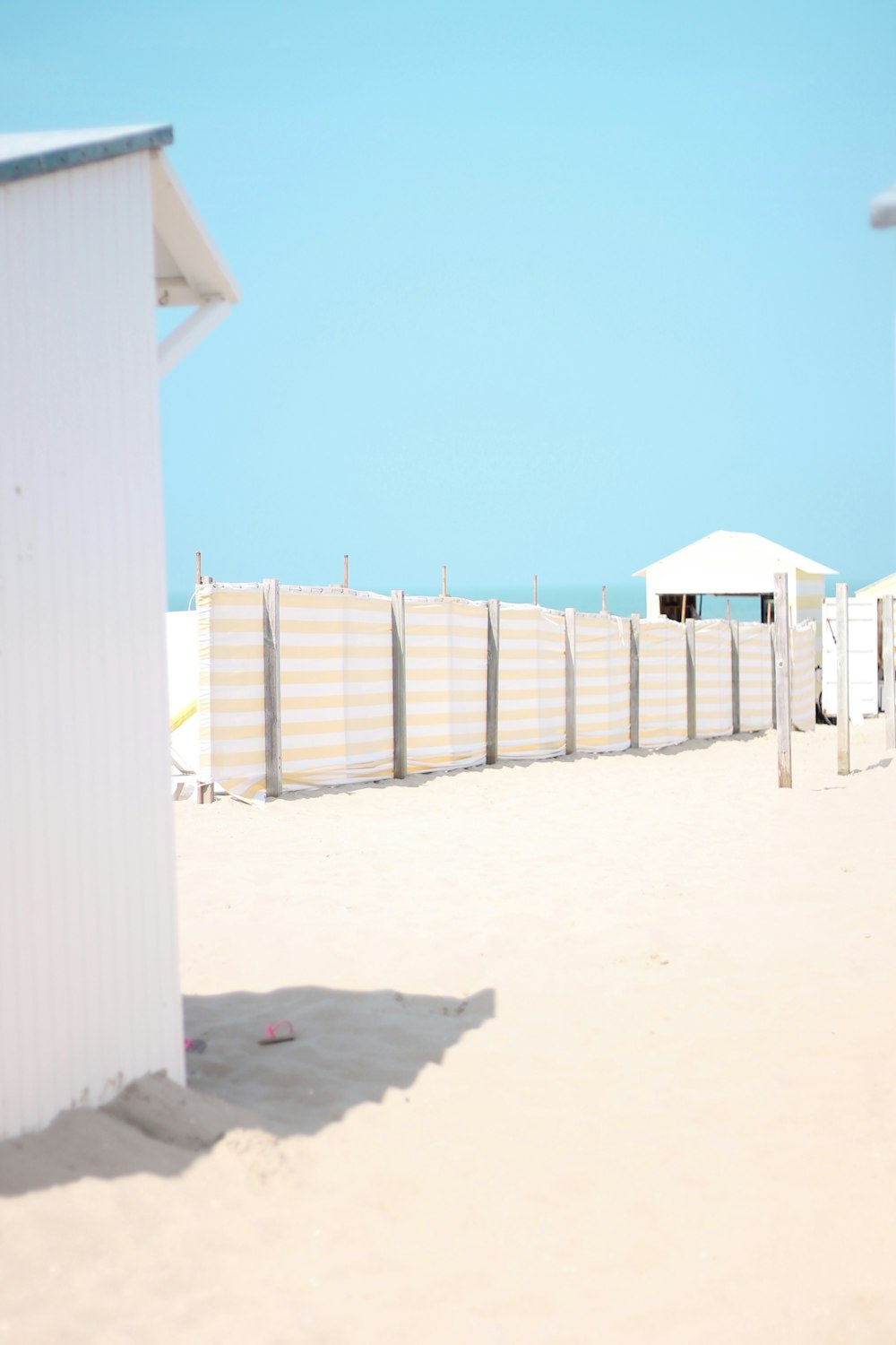tarp fence on white sand