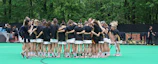 Young female athletes huddled together before a water polo match, showing focus and unity.